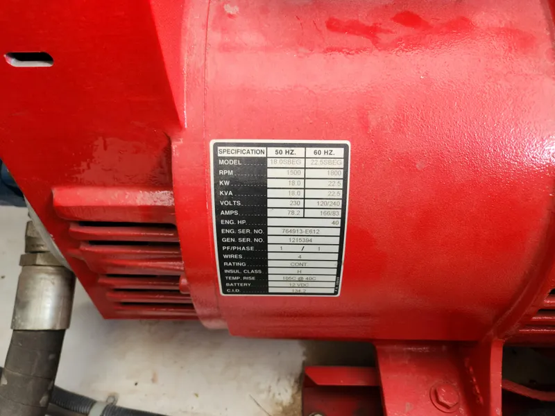 Slide: The Image of Close-up of a red engine with a specification label on a 2008 Sumerset Houseboat. - 28