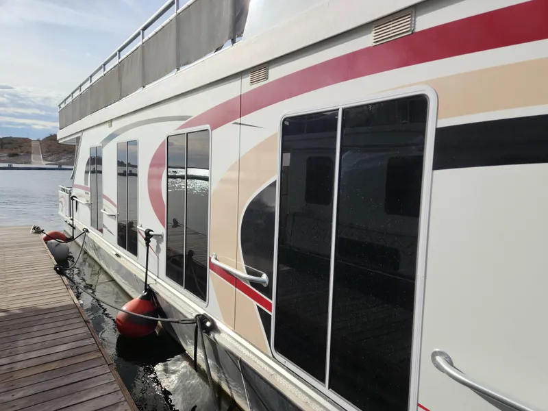 Slide: The Image of 2008 Sumerset Houseboat 20' x 100' docked, side view with modern design. - 3