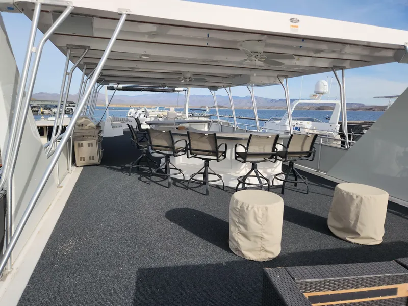 Slide: The Image of Upper deck of a 2008 Sumerset Houseboat 20' x 100' with seating area and lake view. - 4