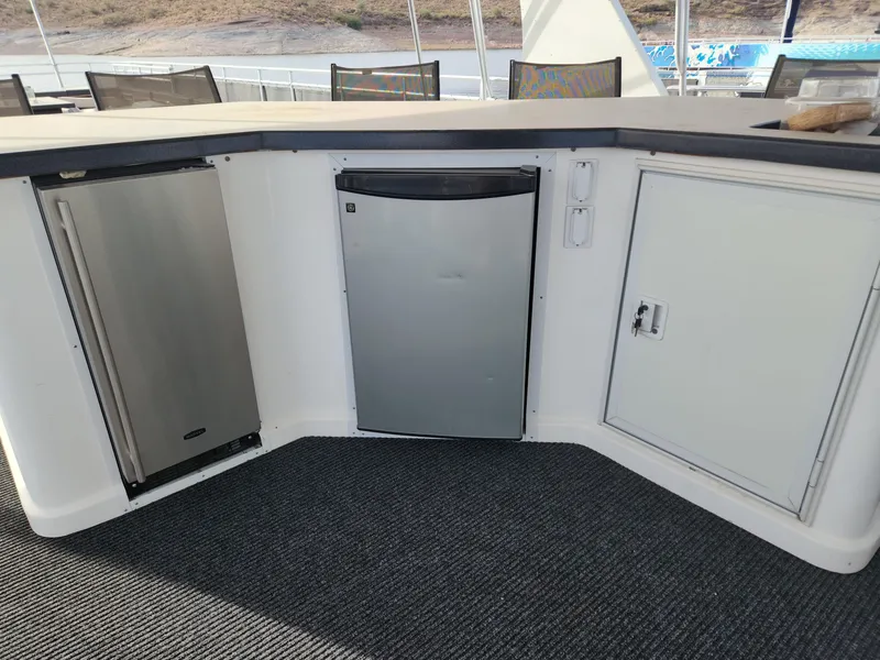Slide: The Image of Outdoor kitchen area on a 2008 Sumerset Houseboat 20' x 100' with mini fridge and storage. - 7