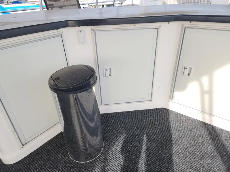 Slide: The Image of Sumerset Houseboat 2008 model interior with storage cabinets and trash bin. - 8