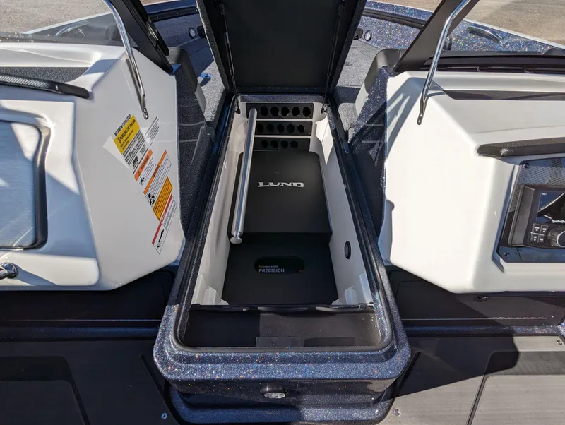 Slide: The Image of 2025 Lund 202 Pro-V GL boat storage compartment with open lid. - 11