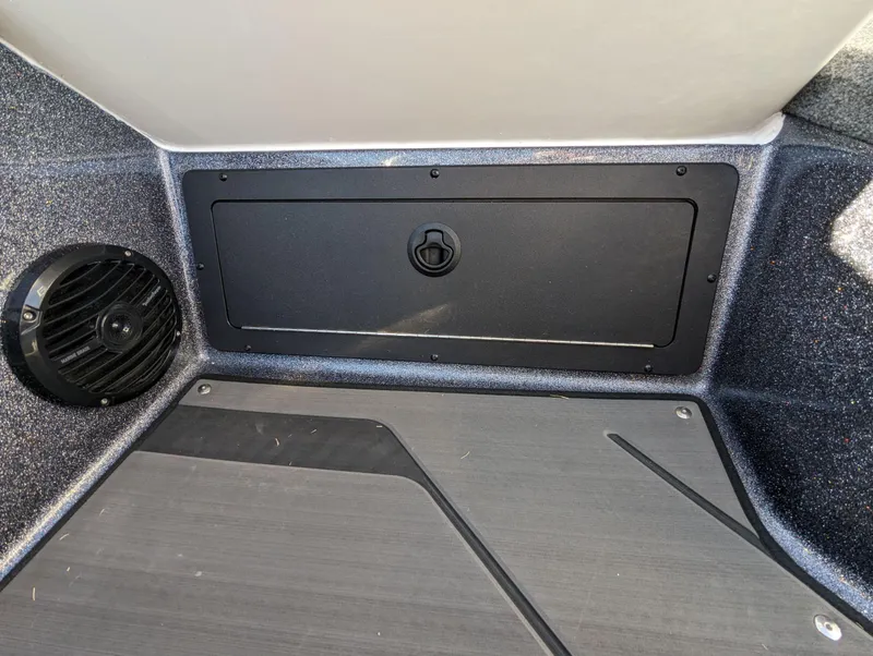 Slide: The Image of 2025 Lund 202 Pro-V GL boat interior storage compartment and speaker. - 12
