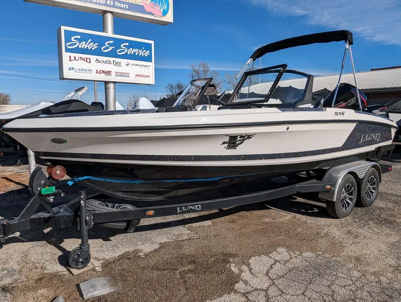 Slide: The Image of 2025 Lund 202 Pro-V GL boat on trailer at dealership. - 15