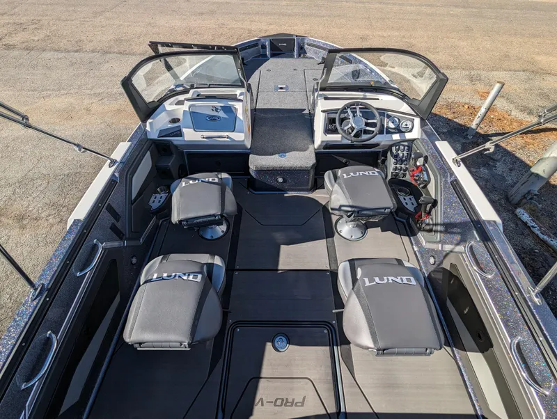 Slide: The Image of 2025 Lund 202 Pro-V GL boat interior with seating and dashboard. - 3