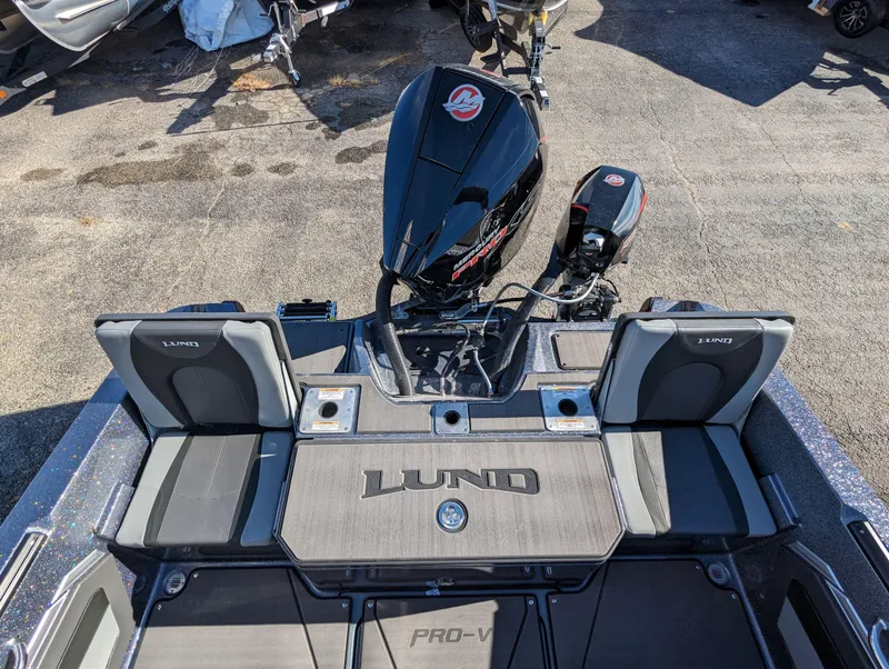 Slide: The Image of 2025 Lund 202 Pro-V GL fishing boat with powerful outboard motor. - 6