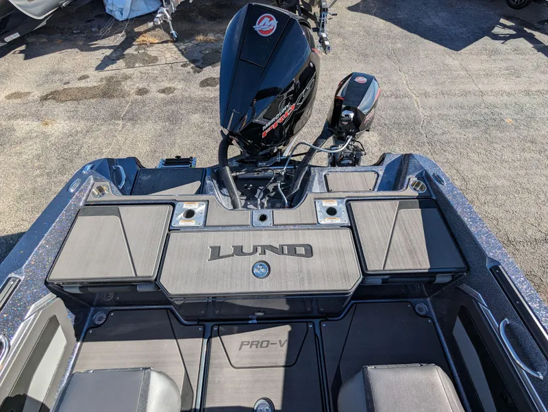 Slide: The Image of 2025 Lund 202 Pro-V GL boat with Mercury outboard motor, rear deck view. - 7