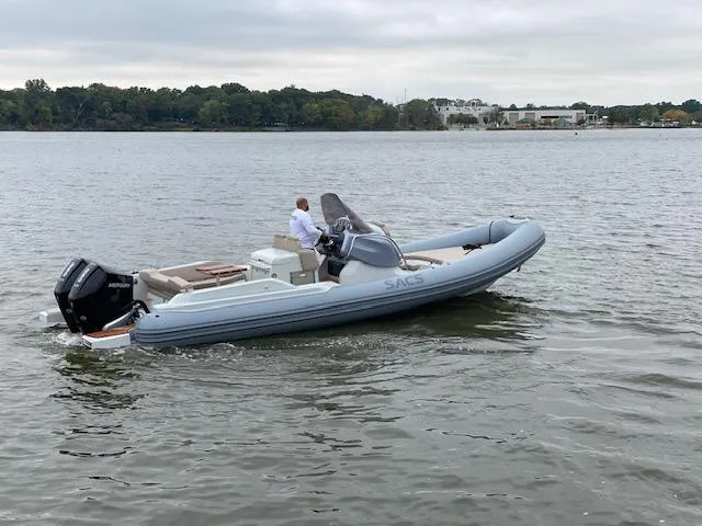 The Image of 2024 SACS Strider 900 inflatable boat cruising on a calm lake. - 0