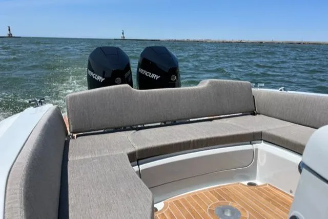 Slide: The Image of 2024 SACS Strider 900 boat with twin Mercury engines on open water. - 10