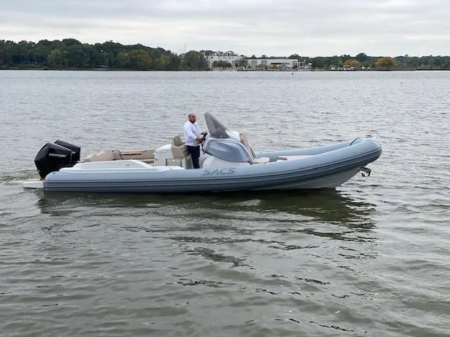 Slide: The Image of 2024 SACS Strider 900 boat cruising on a lake. - 3