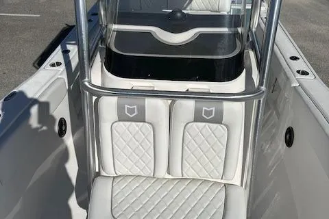 Slide: The Image of 2024 Sea Fox 248 Commander boat interior with white cushioned seating. - 6