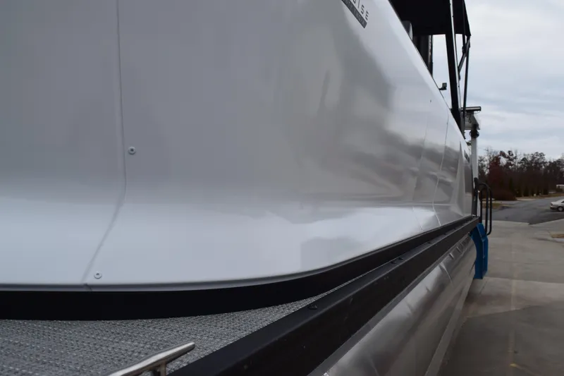 Slide: The Image of 2024 Manitou 22' Cruise Switchback Stealth pontoon boat side view. - 13