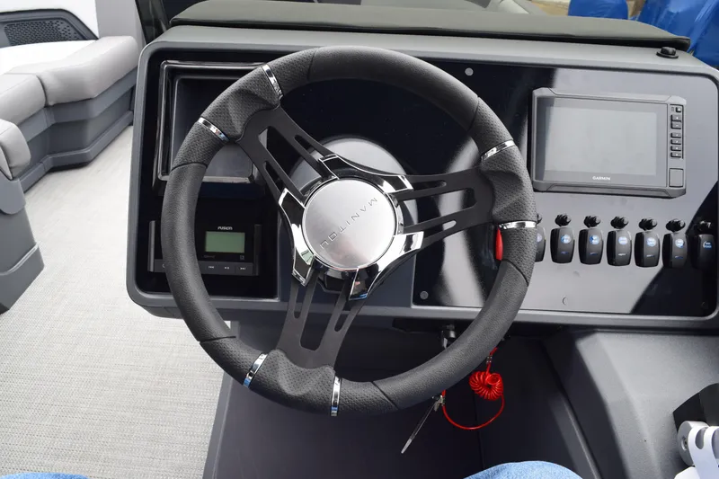 Slide: The Image of Steering console of 2024 Manitou 22' Cruise Switchback Stealth pontoon boat. - 29