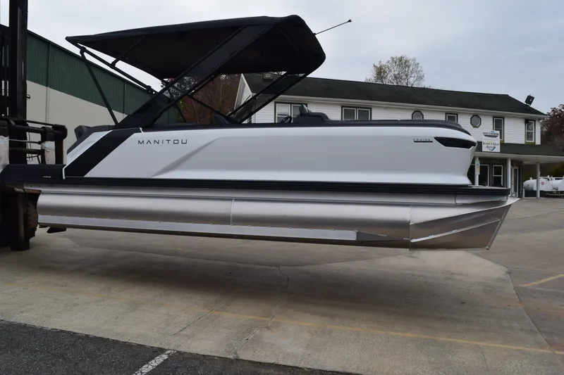 Slide: The Image of 2024 Manitou 22' Cruise Switchback Stealth pontoon boat on display. - 3