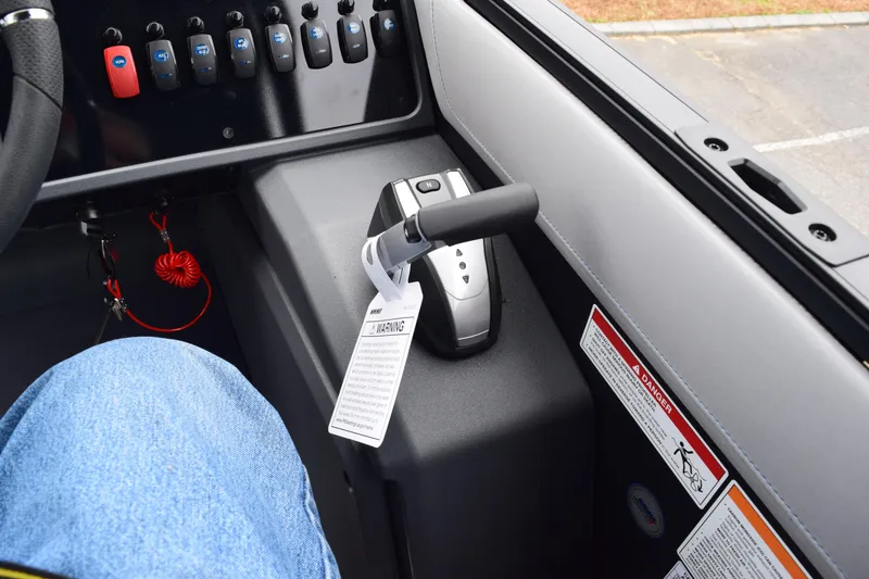 Slide: The Image of 2024 Manitou 22' Cruise Switchback Stealth boat control panel and throttle. - 30