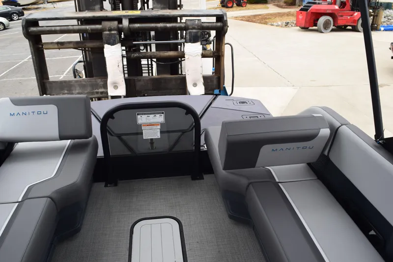 Slide: The Image of 2024 Manitou 22' Cruise Switchback Stealth interior with gray seating and flooring. - 36