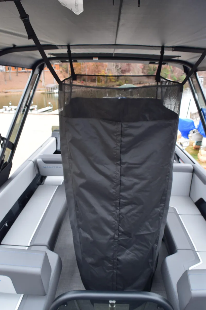 Slide: The Image of 2024 Manitou 22' Cruise Switchback Stealth boat interior with covered seating area. - 44