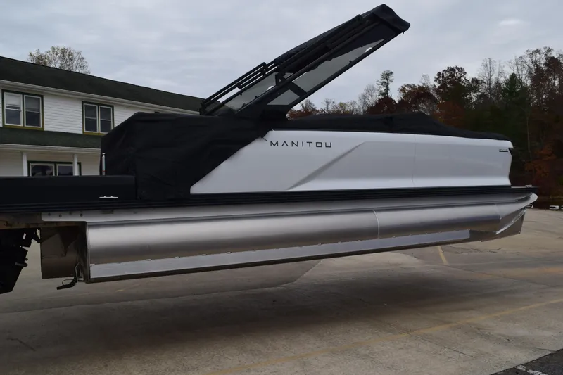Slide: The Image of 2024 Manitou 22' Cruise Switchback Stealth pontoon boat with black cover. - 47