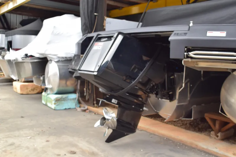 Slide: The Image of 2024 Manitou 22' Cruise Switchback Stealth pontoon boat in storage. - 49