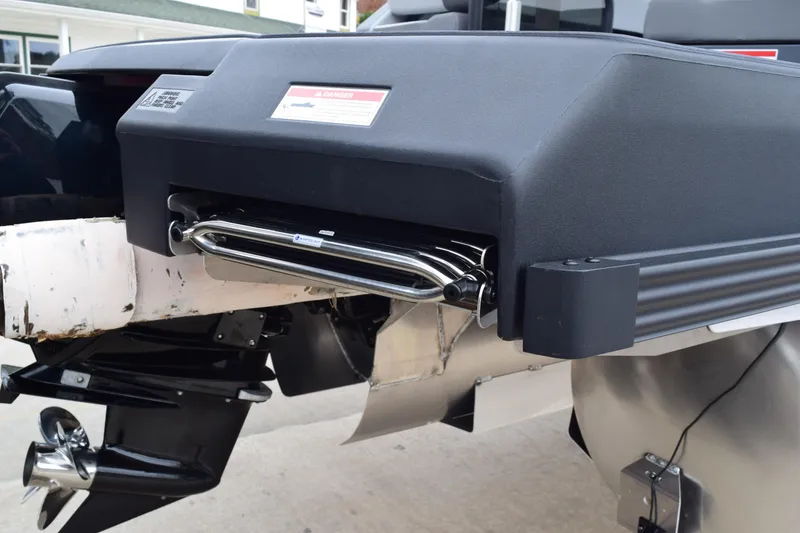 Slide: The Image of 2024 Manitou 22' Cruise Switchback Stealth boat rear view with motor and ladder. - 8