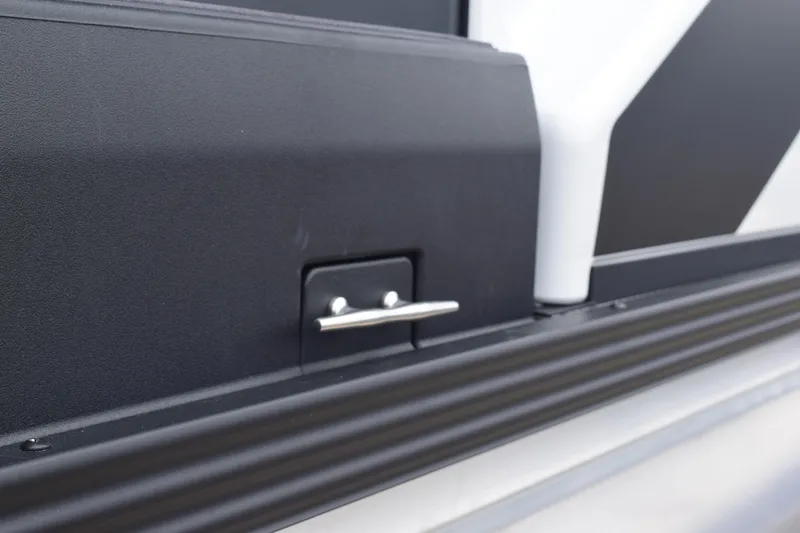 Slide: The Image of 2024 Manitou 22' Cruise Switchback Stealth boat detail, featuring sleek black and white design. - 9