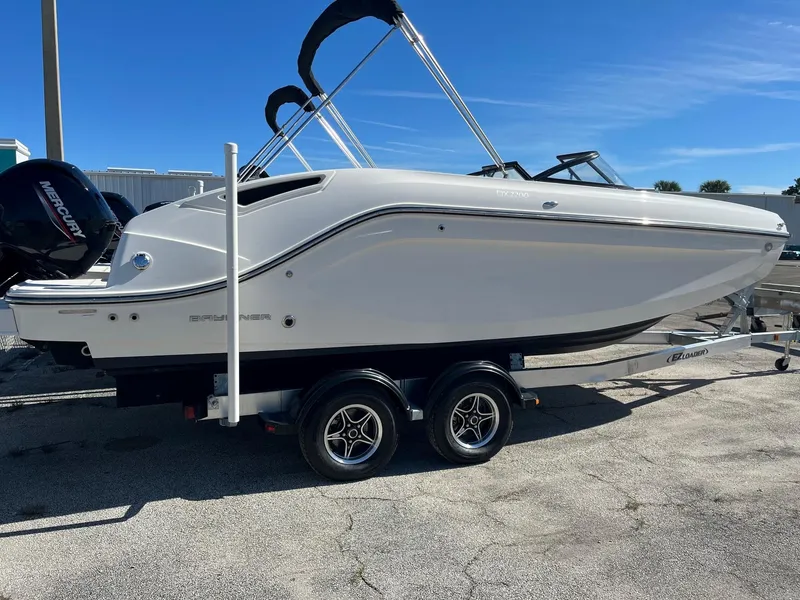 Slide: The Image of 2021 Bayliner DX 2200 boat on trailer at dealership. - 3