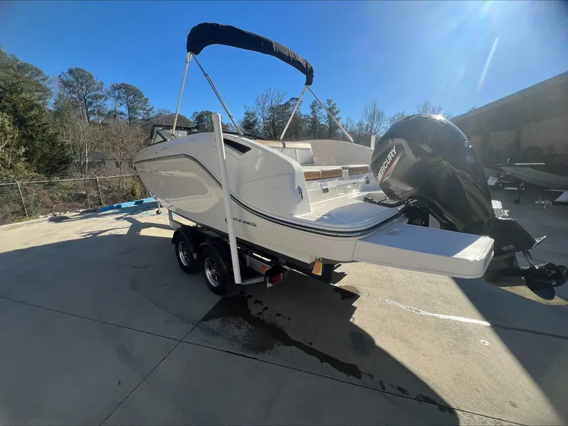 Slide: The Image of 2021 Bayliner DX 2200 boat on trailer with outboard motor. - 5