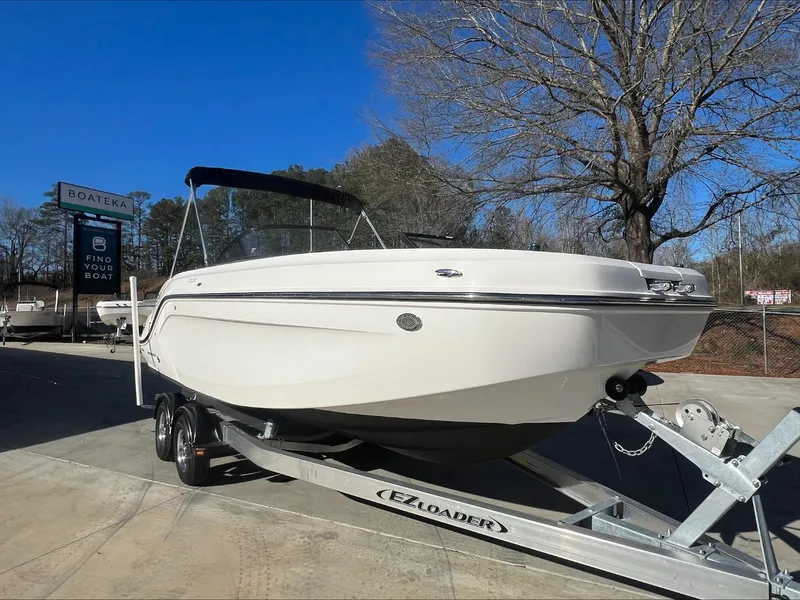 Slide: The Image of 2021 Bayliner DX 2200 boat on EZ Loader trailer at dealership. - 8