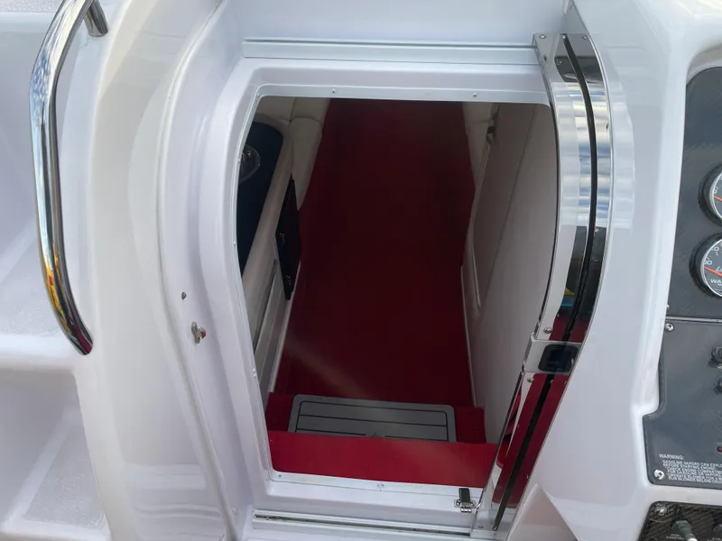 Slide: The Image of 2007 Donzi 38 ZR boat cabin entrance with red carpet and white interior. - 12