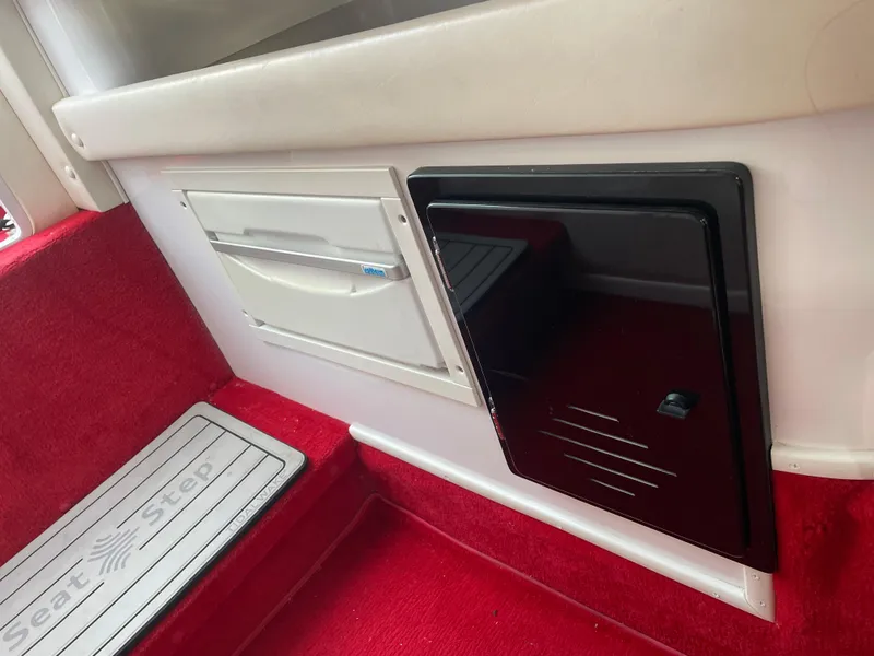 Slide: The Image of Interior of 2007 Donzi 38 ZR boat with red carpet and storage compartments. - 15