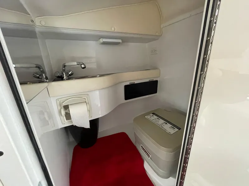 Slide: The Image of 2007 Donzi 38 ZR boat interior bathroom with sink and portable toilet. - 17
