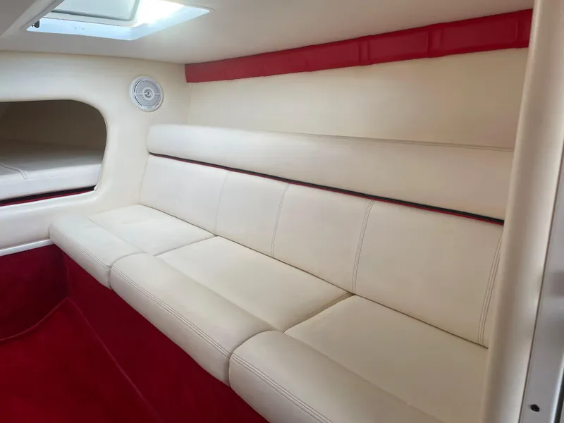 Slide: The Image of Interior of 2007 Donzi 38 ZR boat with white leather seating and red accents. - 18