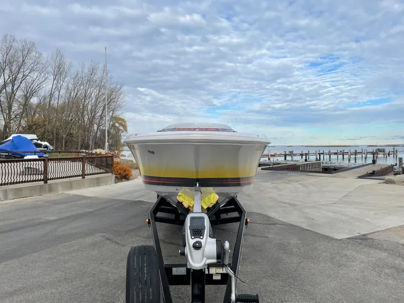 Slide: The Image of 2007 Donzi 38 ZR speedboat on trailer at a lakeside dock. - 2