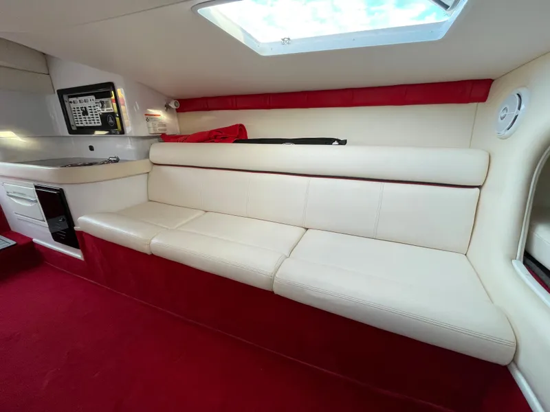 Slide: The Image of Interior of 2007 Donzi 38 ZR boat with white leather seating and red accents. - 21