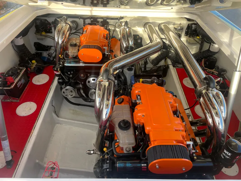 Slide: The Image of 2007 Donzi 38 ZR engine compartment with dual orange engines and chrome exhausts. - 27