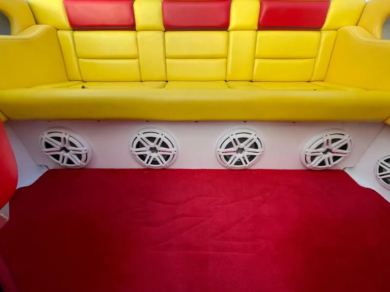 Slide: The Image of 2007 Donzi 38 ZR boat interior with yellow and red seating, red carpet, and multiple speakers. - 28
