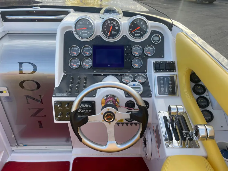 Slide: The Image of 2007 Donzi 38 ZR boat dashboard with steering wheel and gauges. - 29