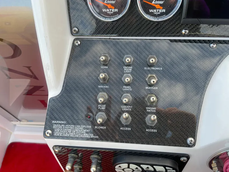 Slide: The Image of 2007 Donzi 38 ZR boat dashboard with control switches and gauges. - 30