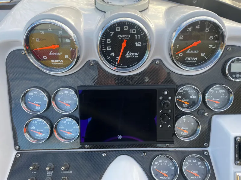 Slide: The Image of 2007 Donzi 38 ZR dashboard with Livorsi gauges and GPS display. - 31