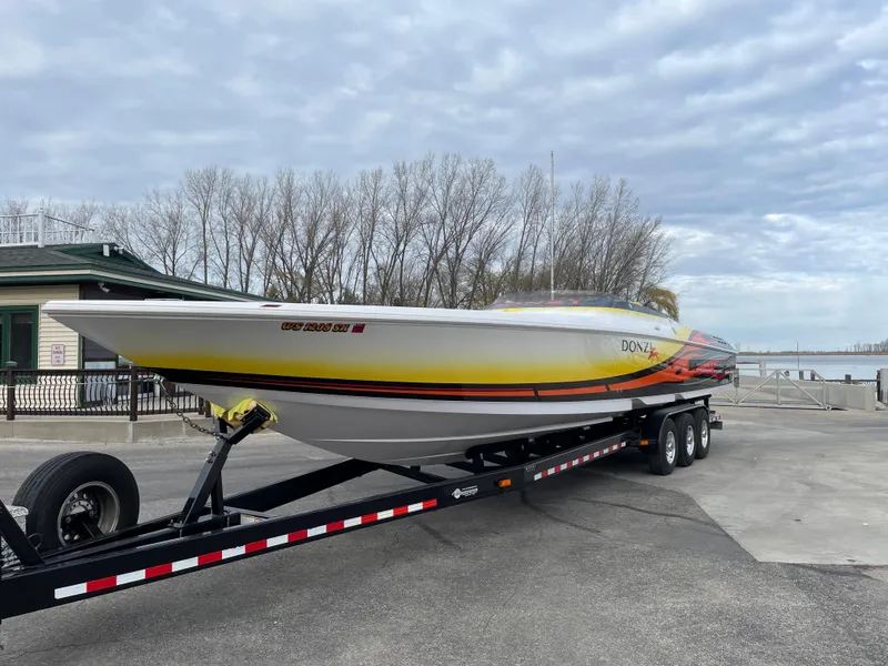 Slide: The Image of 2007 Donzi 38 ZR speedboat on a trailer, parked near a waterfront. - 4