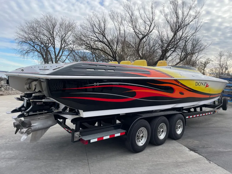 Slide: The Image of 2007 Donzi 38 ZR speedboat with vibrant flame graphics on a trailer. - 8