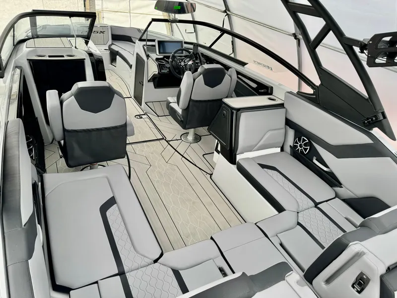 Slide: The Image of 2024 Yamaha Boats 255 XE interior, featuring modern seating and advanced dashboard. - 11