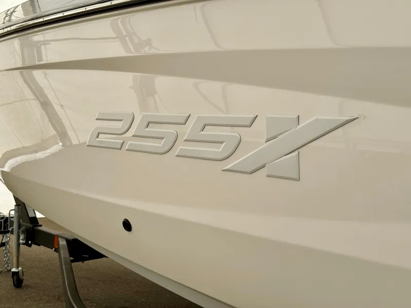 Slide: The Image of 2024 Yamaha Boats 255 XE side view with model emblem. - 2