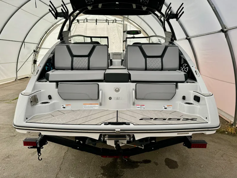 Slide: The Image of 2024 Yamaha Boats 255 XE rear view in a covered storage area. - 5
