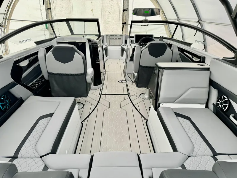 Slide: The Image of 2024 Yamaha Boats 255 XE interior with modern seating and sleek design. - 7
