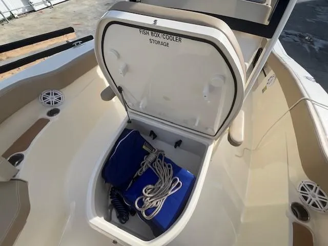 Slide: The Image of 2023 Scout 215XSF boat with open fish box cooler storage. - 10