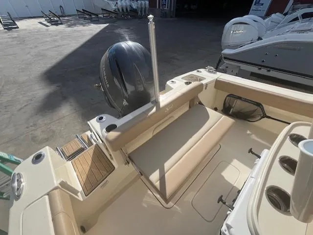 Slide: The Image of 2023 Scout 215XSF boat interior with seating and outboard motor. - 13