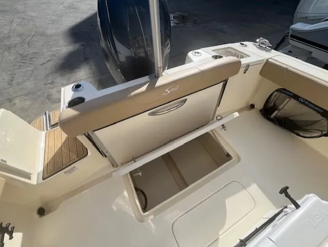 Slide: The Image of 2023 Scout 215XSF boat interior with storage compartment and seating. - 14