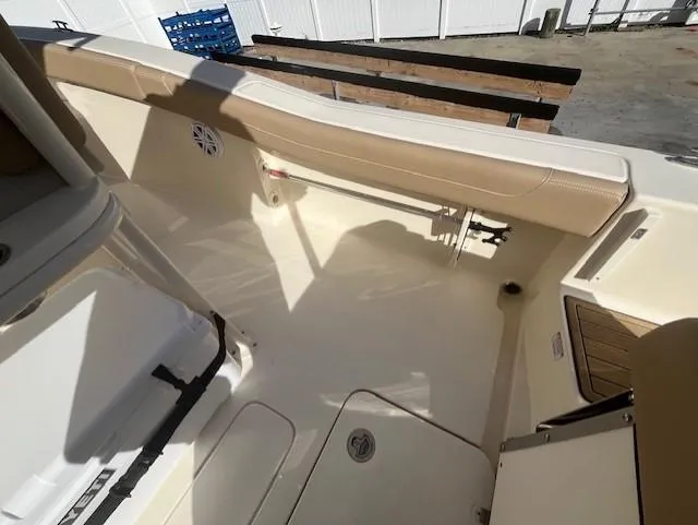 Slide: The Image of 2023 Scout 215XSF boat interior with beige seating and white deck. - 18