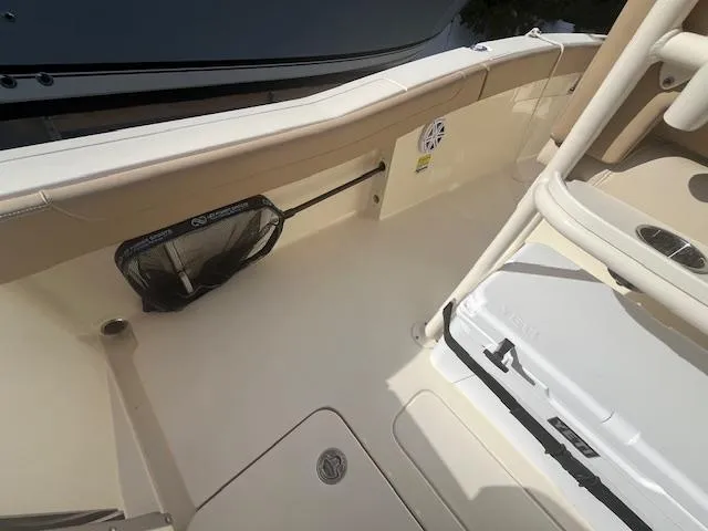 Slide: The Image of 2023 Scout 215XSF boat interior with storage net and cooler. - 20